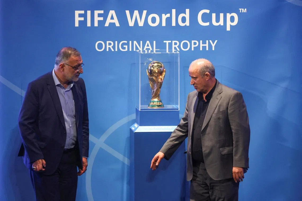 FILE PHOTO: President of Iran Football Federation Mehdi Taj and Mayor of Tehran Alireza Zakani stand next to the FIFA World Cup Trophy during an unveiling ceremony in Tehran, Iran September 1, 2022.  Majid Asgaripour/WANA (West Asia News Agency) via REUTERS /File Photo