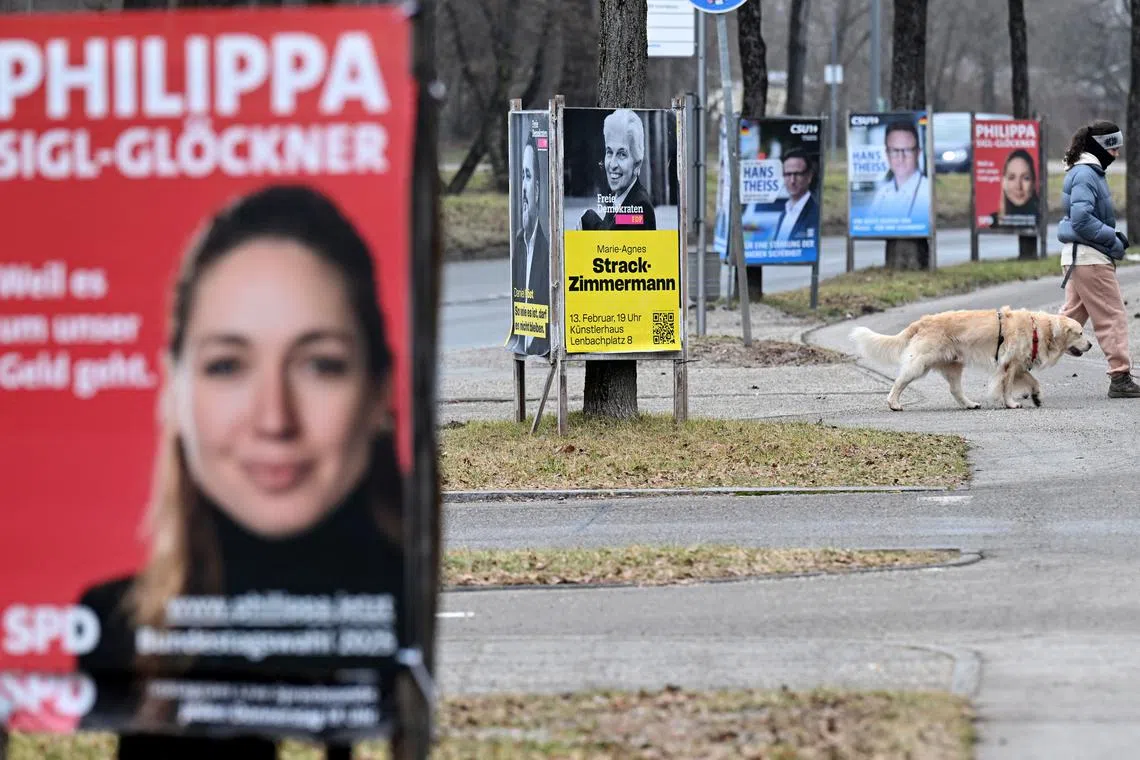 Election campaign posters for the upcoming general election stand next to a street in Munich, Germany, February 6, 2025. REUTERS/Angelika Warmuth