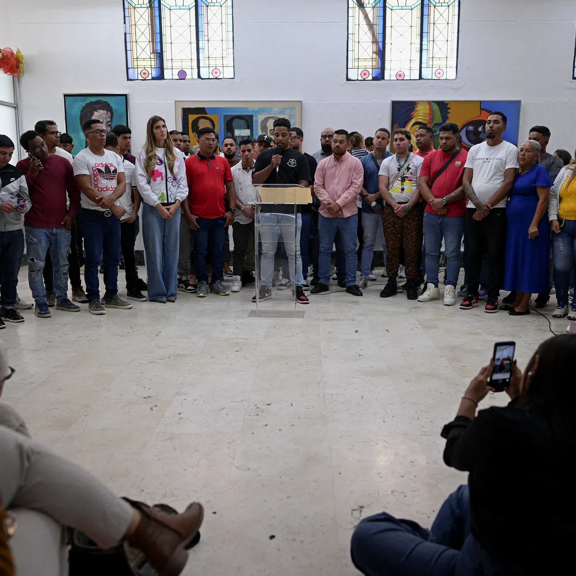 Venezuelans who where imprisoned in El Salvador's CECOT mega-prison give statements to the press, in Caracas, Venezuela, December 26, 2025. REUTERS/Gaby Oraa