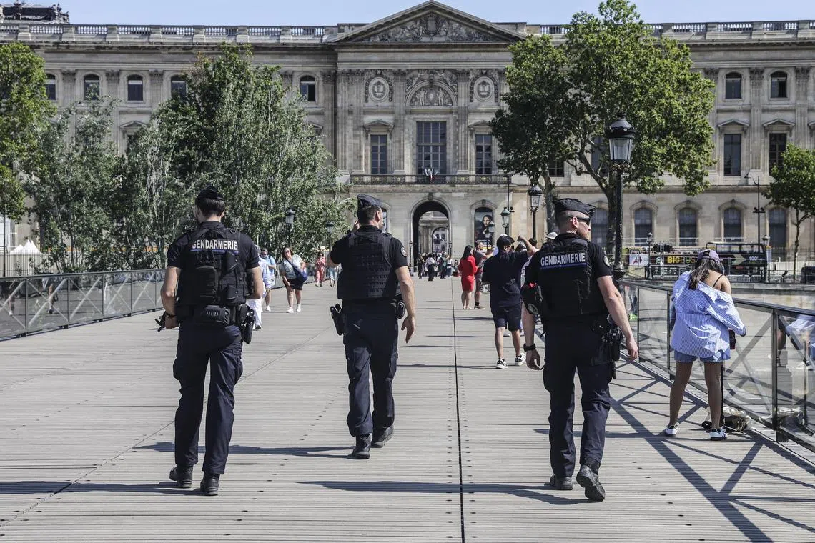 Members of the French Gendarmerie patrol Pont des Arts bridge in Paris.