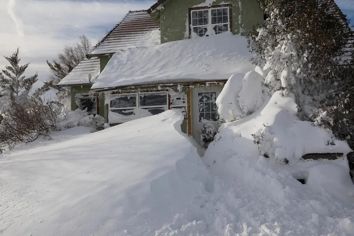 Snow blanketing a house following a blizzard in Sturgis, South Dakota, on Dec 16, 2022. 