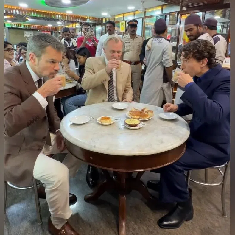 (From left) Matt Damon, Christopher Nolan and Tom Holland enjoying a cup of chai and bun maska in India’s famous Olympia Coffee House in Colaba on July 10.