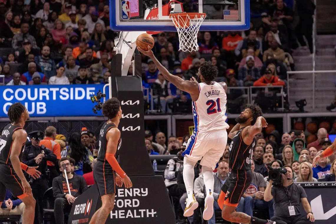 Philadelphia 76ers centre Joel Embiid drives to the basket next to Detroit Pistons guard Killian Hayes during the second half at Little Caesars Arena.