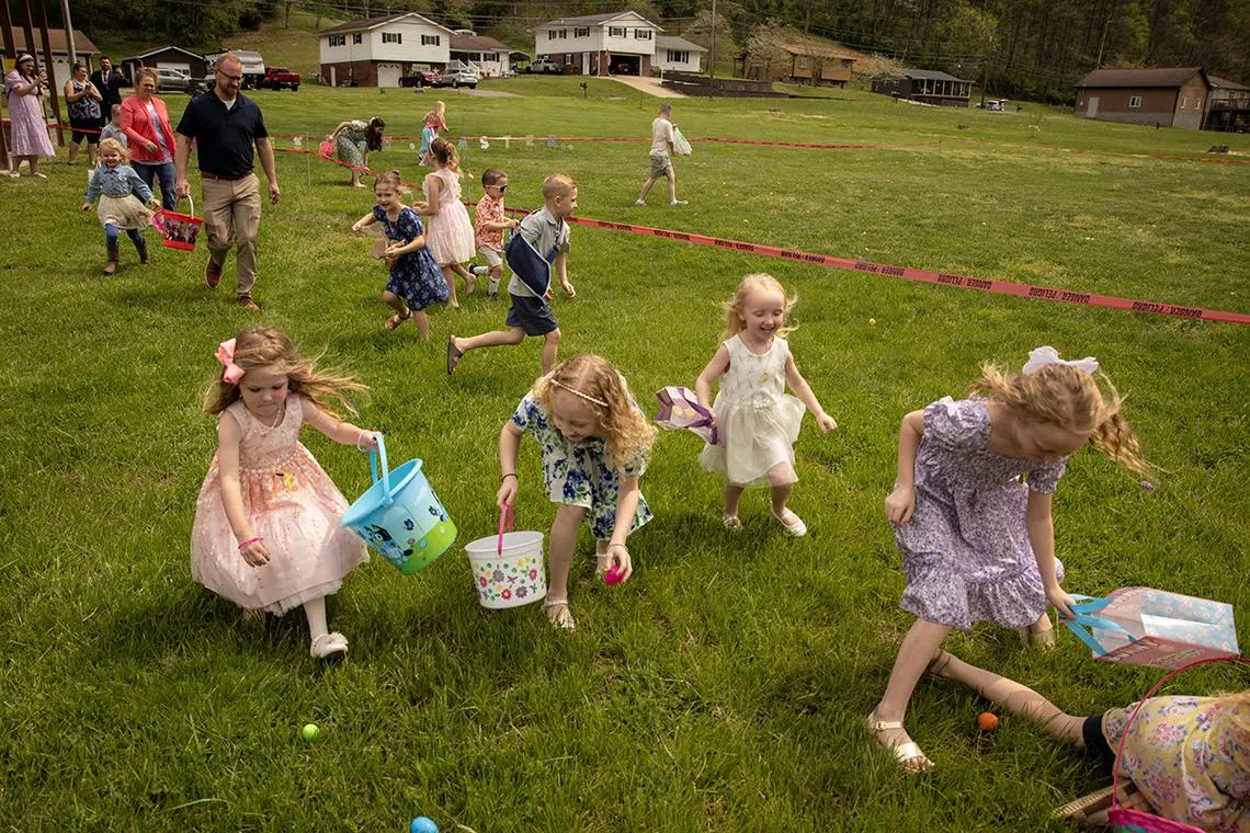 Children, including Everly Dickens, 4, Mea Milam, 8, and Demi Jones, 4, participate in an Easter egg hunt following the service at Amazing Grace Fellowship church in Seth, West Virginia, U.S., April 20, 2025. REUTERS/Adrees Latif