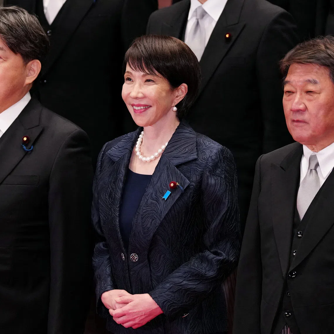 Japanese Prime Minister Sanae Takaichi (front C) and her new cabinet members pose for a group photo in Tokyo, Japan, Oct. 21, 2025.    Jia Haocheng/Pool via REUTERS