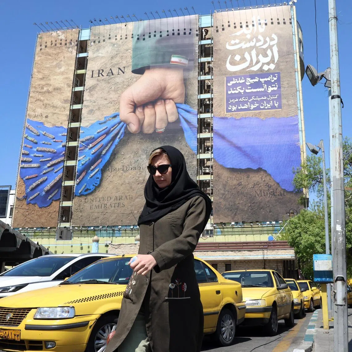 A billboard referring to the Strait of Hormuz and reading in Persian “Forever on Iran's hand” is displayed in Tehran.
