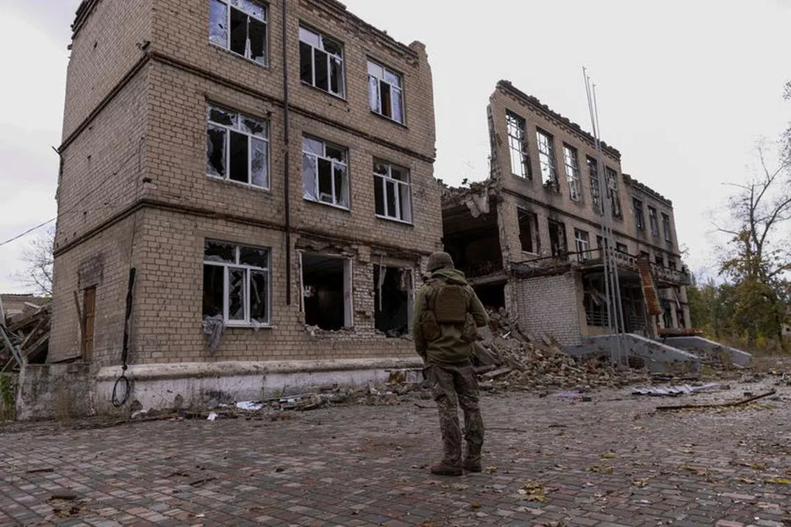FILE PHOTO: A police officer stands in front of a damaged building, amid Russia's attack on Ukraine, in the town of Avdiivka, Donetsk region, Ukraine October 17, 2023. REUTERS/Yevhen Titov/File Photo