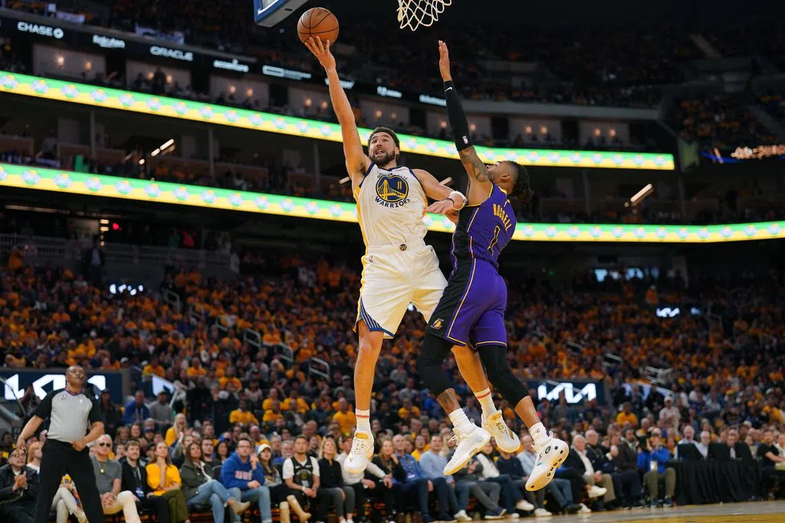 Golden State Warriors guard Klay Thompson makes a layup in front of Los Angeles Lakers guard D'Angelo Russell during Game 2 of their NBA Western Conference semi-final play-offs.