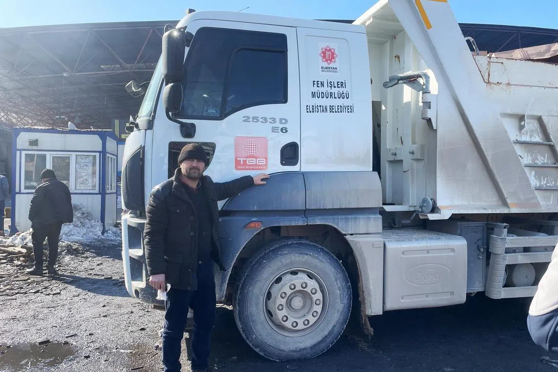 Samuel Devaraj/<slturkey19>/Mr Kazim Erdogan standing infront of the truck he uses to deliver items like stoves for the needy. Despite losing family members in the earthquake, he is volunteering driving items like stoves to people in need.
