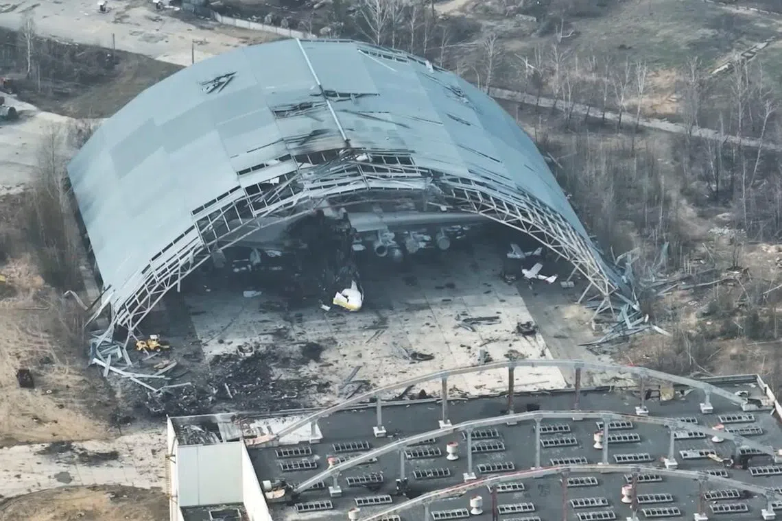 A damaged aircraft is seen in a destroyed hangar at the Antonov International Airport, near Hostomel, Ukraine, March 31, 2022, in this still image obtained from a social media video taken with a drone on March 31, 2022. Babylon'13/via REUTERS/File Photo