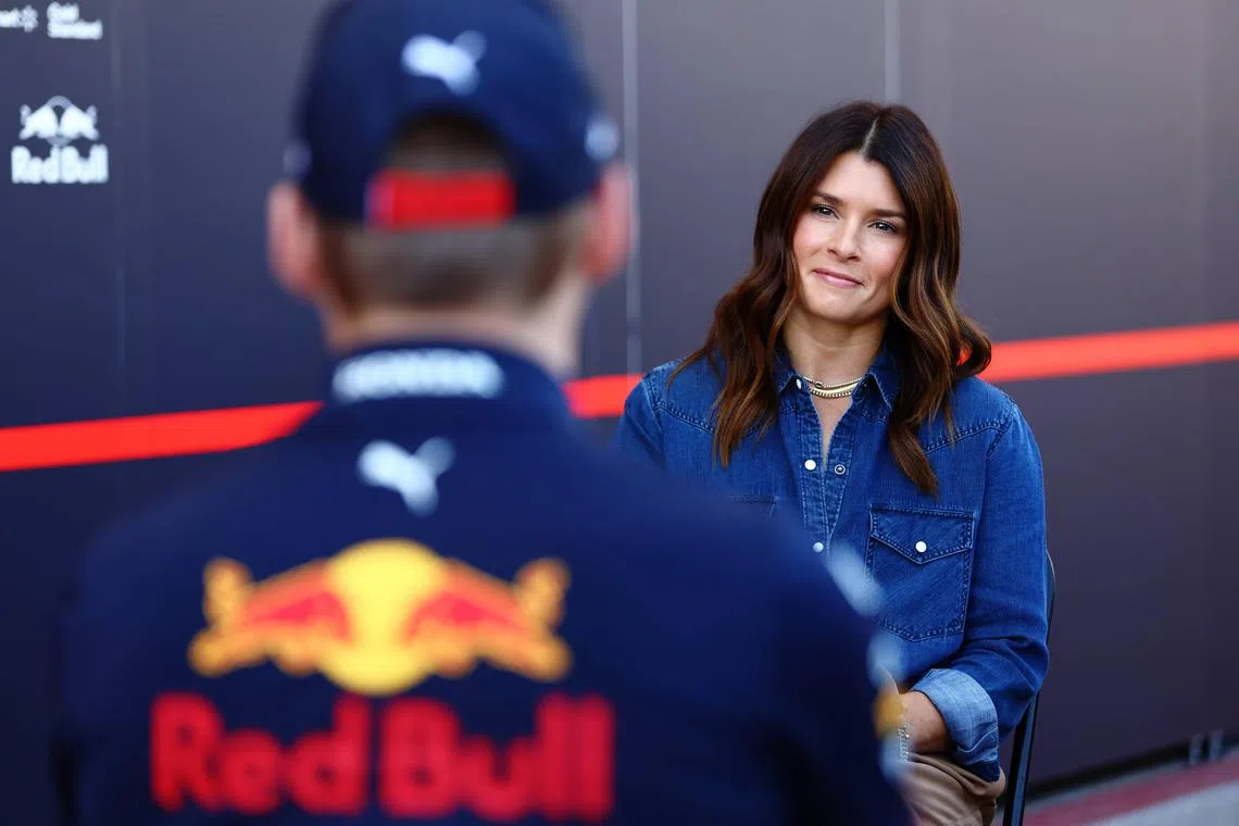Danica Patrick talking with Max Verstappen of the Netherlands and Red Bull Racing in the paddock during practice ahead of the United States Formula One Grand Prix at Circuit of The Americas on Oct 21.