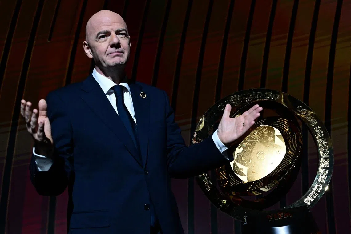 Fifa president Gianni Infantino standing next to the 2025 Club World Cup trophy on Dec 5, during the draw for the July competition.