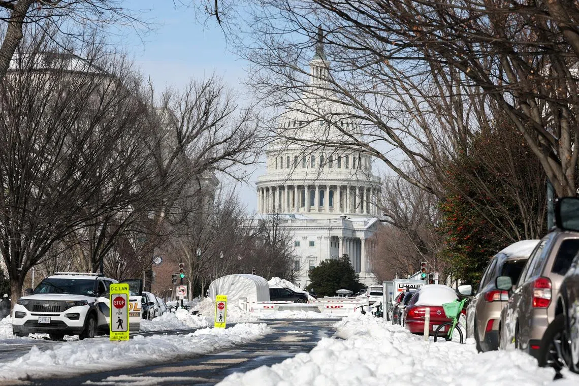 Snow covers a street near the US Capitol building in Washington on Jan 27, two days after a winter storm swept across a large swathe of the US.