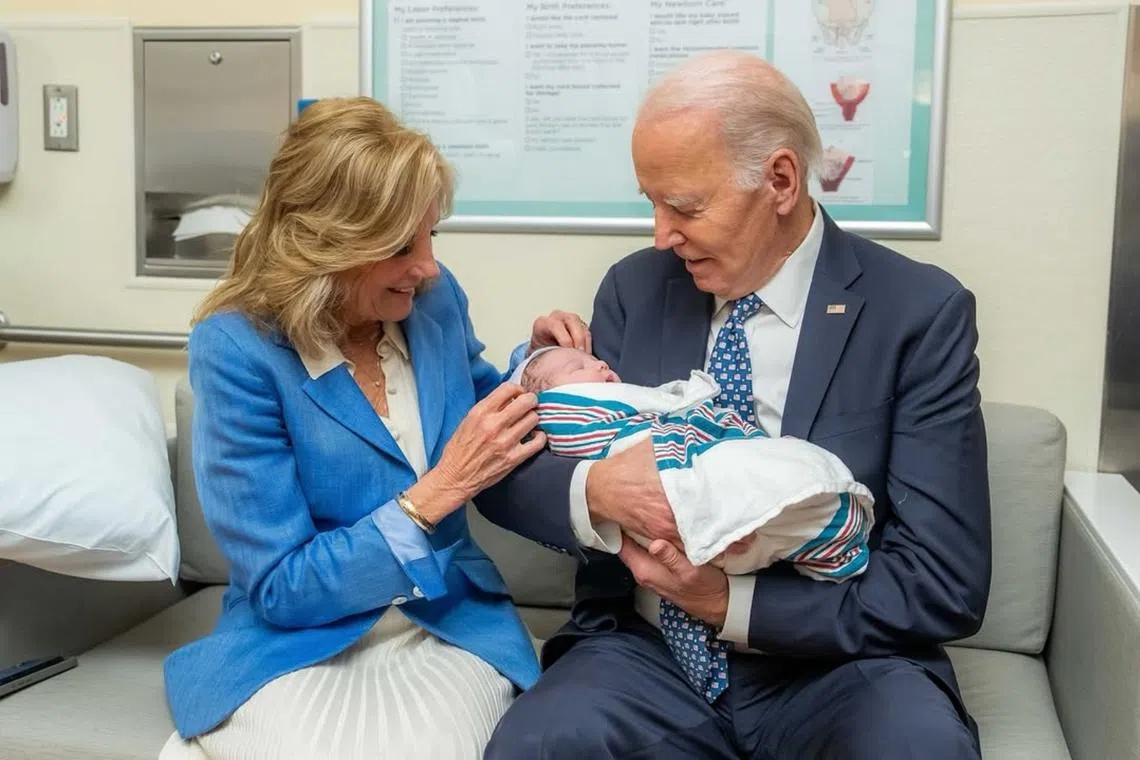 Mr Joe Biden held the boy, who was wrapped in a blue-striped blanket, while Mrs Biden tugged a hat over his dark hair.