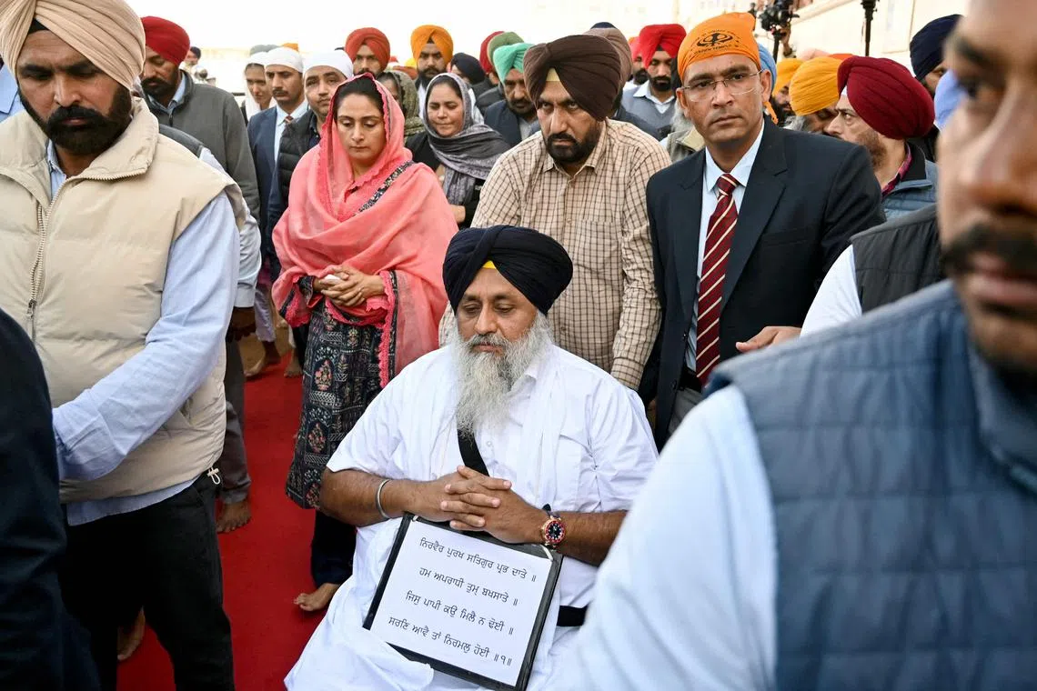 Security personnel escort Mr Sukhbir Singh Badal (centre) after he was nearly shot by a gunman at the Golden Temple in Amritsar.