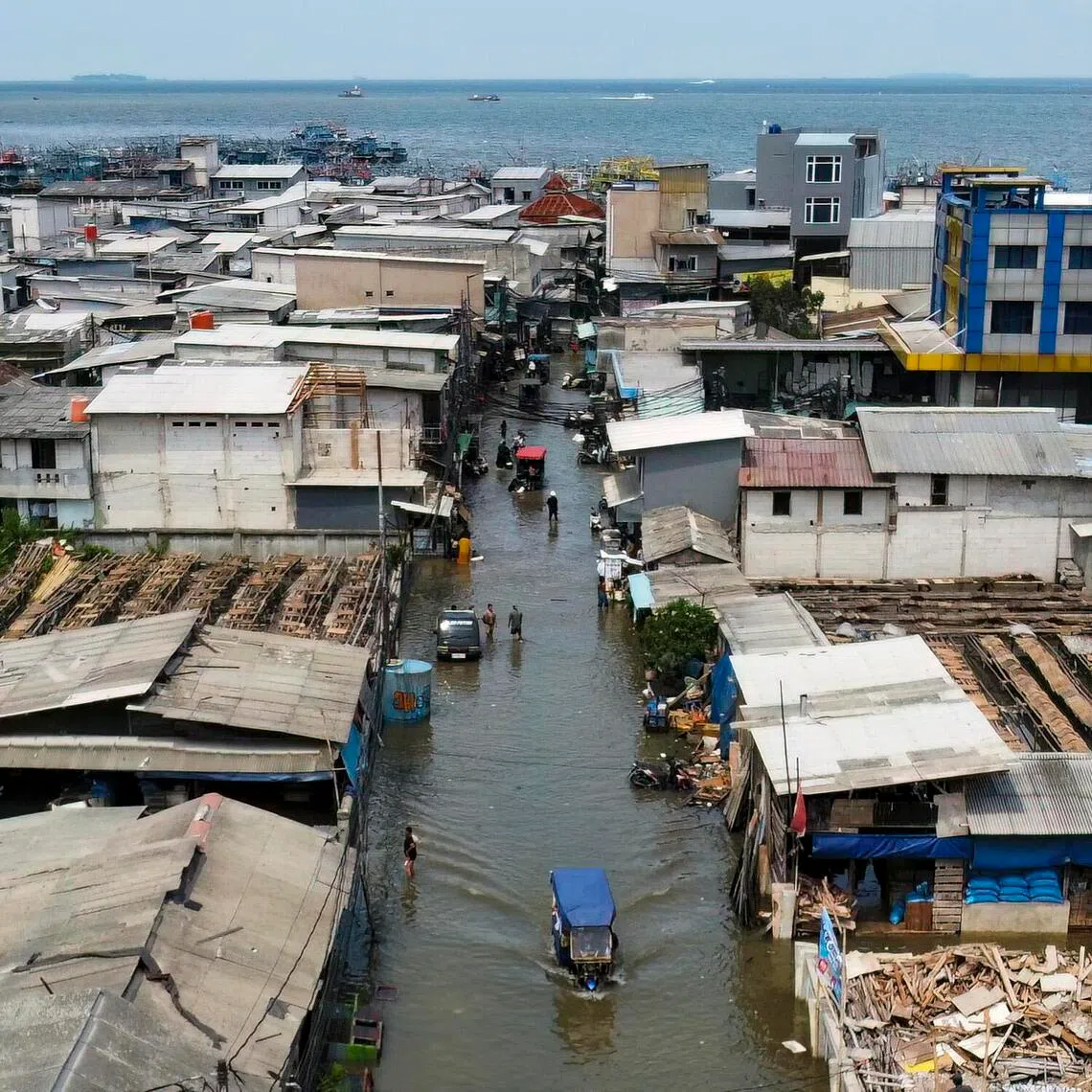 This aerial picture shows a settlement submerged by high tide in Muara Baru, Jakarta on Dec 6, 2025.