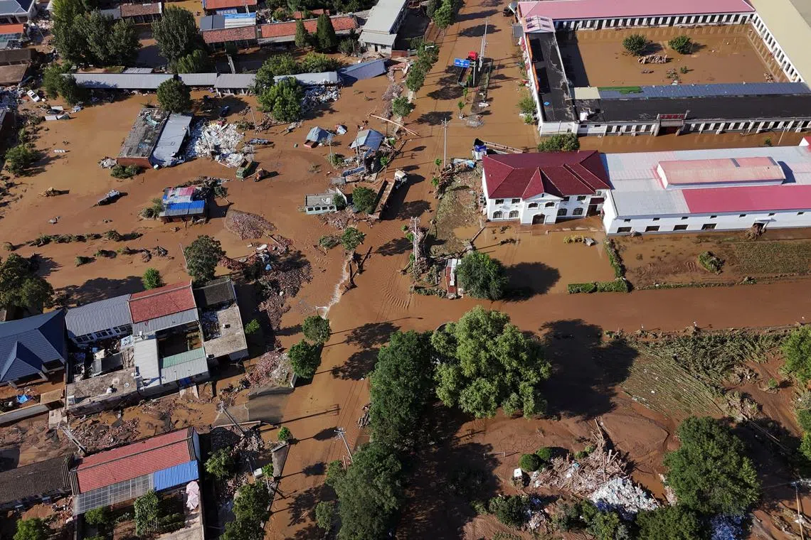 Partially submerged village houses are seen in the Miyun district of Beijing. China has suffered weeks of extreme weather since July.