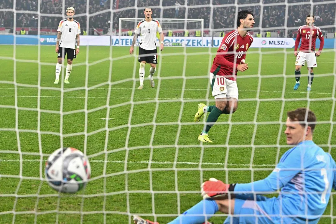 Hungary midfielder Dominik Szoboszlai scoring the equaliser from the penalty spot, past Germany's goalkeeper Alexander Nuebel.