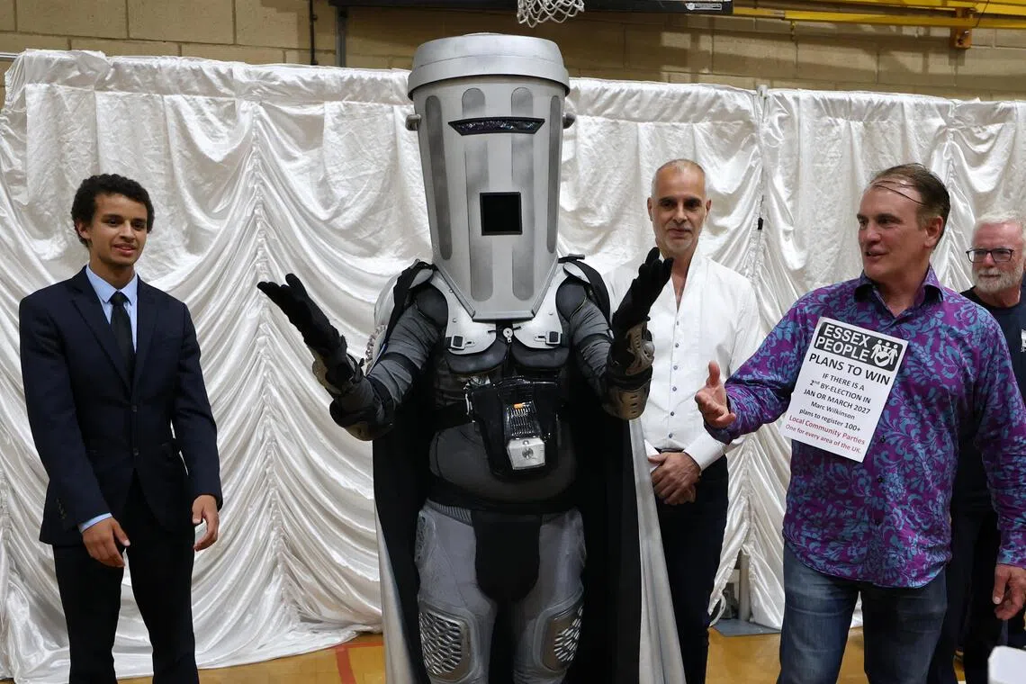Wearing a towering grey helmet and visor in the shape of a rubbish bin, Binface, is the alter ego of comedian Jon Harvey.