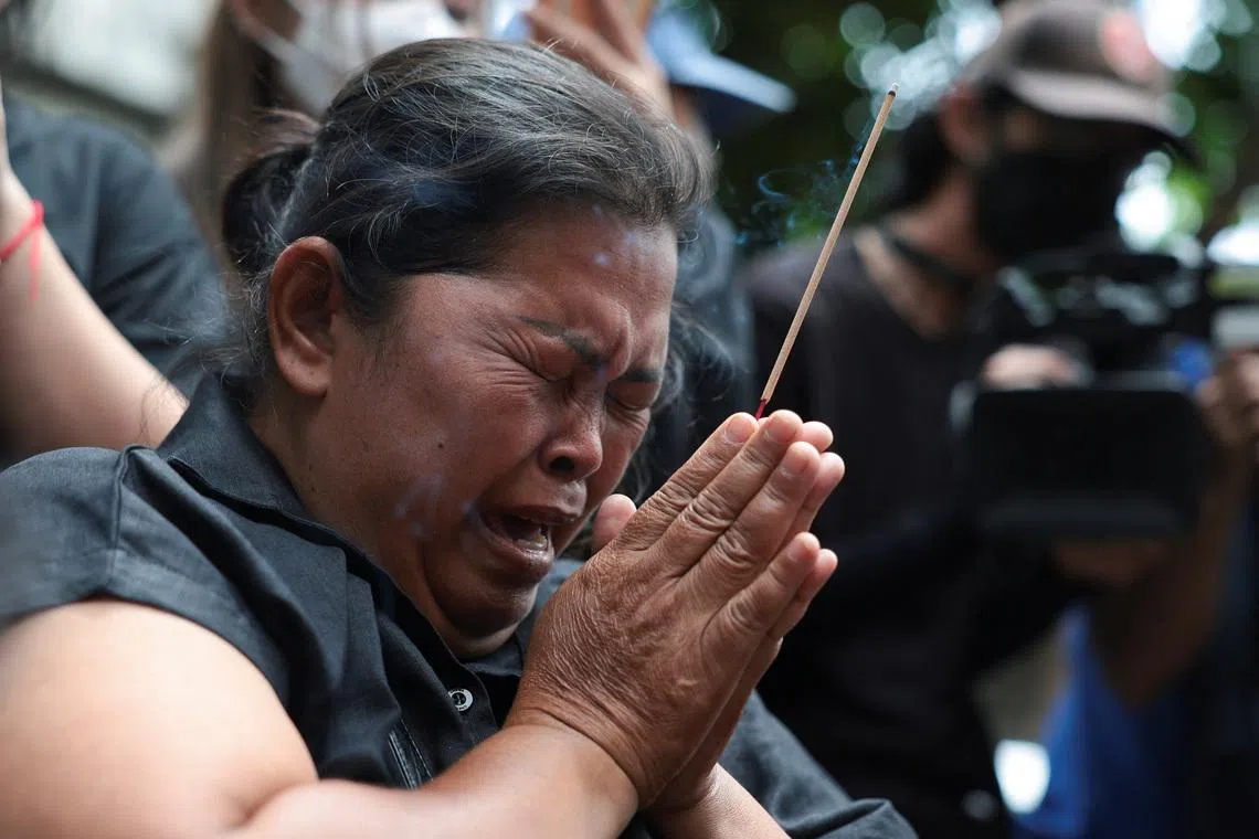 Mother of the victim, Kanokthip Srisuk, visits Rong Beer Na Lat Phrao bar, the site of a deadly fire, to pay tribute to Srisuk and other victims who lost their lives in the bar fire, the day after the incident, in Bangkok, Thailand, July 14, 2026. REUTERS/Chalinee Thirasupa