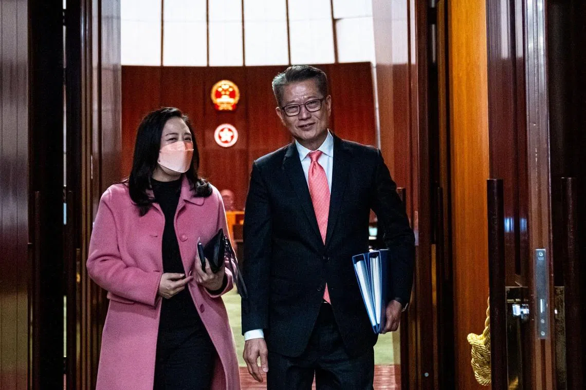 Paul Chan, Hong Kong's financial secretary, right, departs with Elizabeth Quat, member of the Legislative Council, following his budget presentation in Hong Kong, China, on Wednesday, Feb. 28, 2024. Hong Kong's government is removing cooling measures to boost the lackluster residential market and provide additional funds to boost tourism as part of a sweeping plan to revive growth in the ailing financial hub. Photographer: Lam Yik/Bloomberg