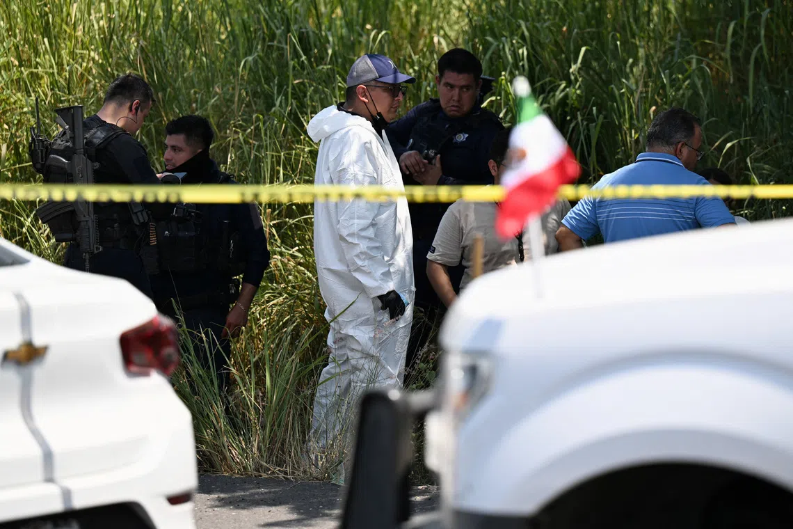 A forensic technician and police officers stand at the scene where Zenyazen Escobar, a federal legislator from Veracruz, home to some of Mexico's major oil complexes, was found dead with at least one gunshot wound on a highway linking the municipality of Puente Nacional with the state capital, Xalapa, Mexico, September 4, 2026. REUTERS/Yahir Ceballos