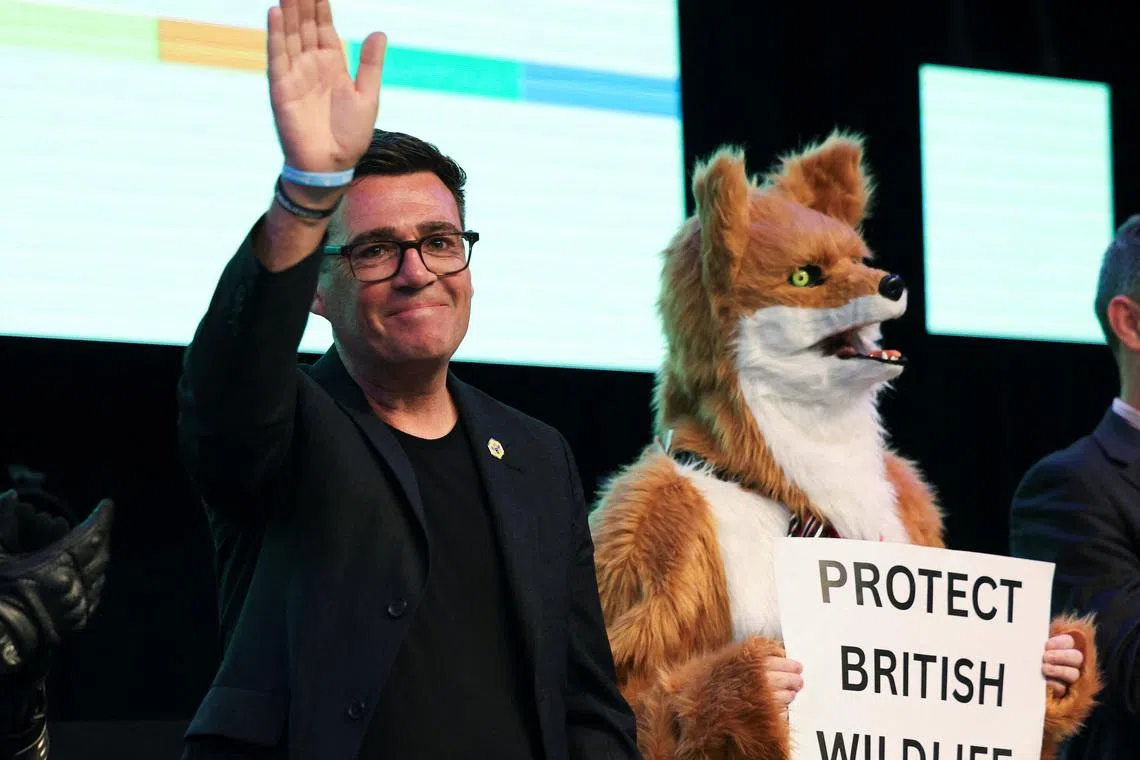 Newly elected Makerfield MP Andy Burnham of Britain's Labour Party reacts following his victory in the Makerfield by-election.