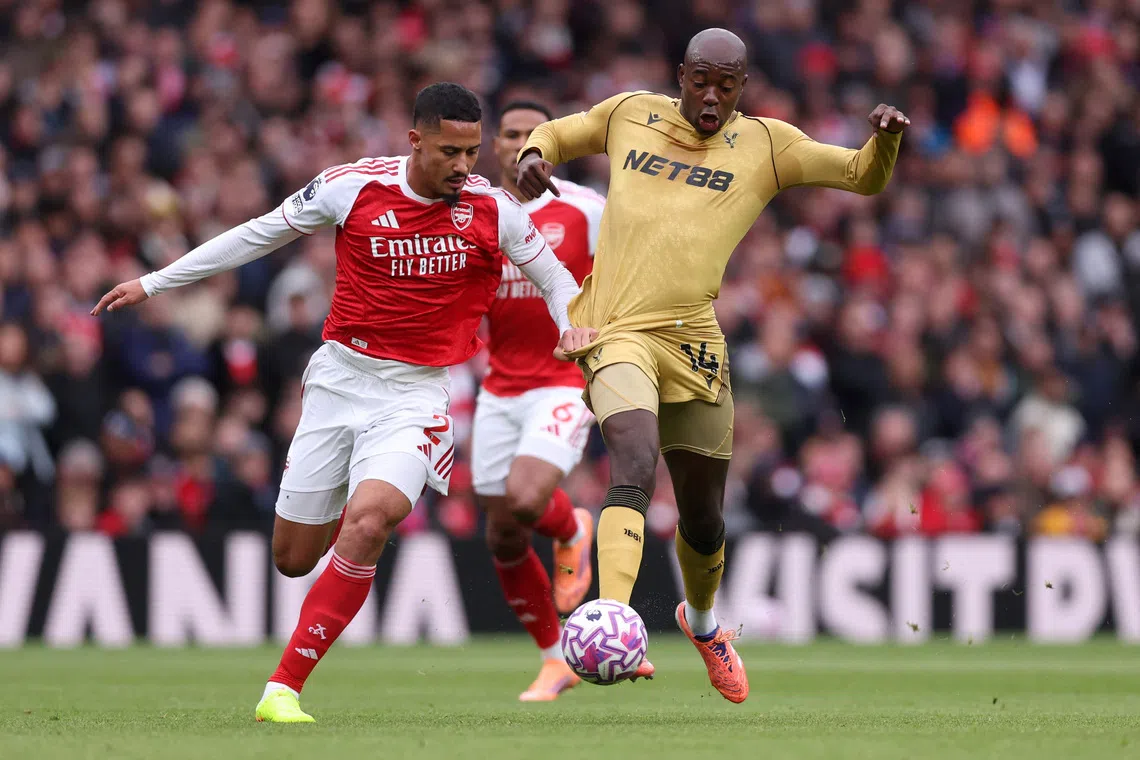 Soccer Football - Premier League - Arsenal v Crystal Palace - Emirates Stadium, London, Britain - October 26, 2025 Arsenal's William Saliba in action with Crystal Palace's Jean-Philippe Mateta REUTERS/David Klein