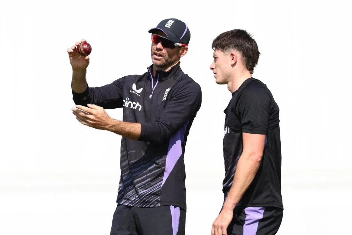 England's Matthew Potts with the team's fast bowling mentor James Anderson during practice at Trent Bridge Cricket Ground in  Nottingham on July 17, 2024.
