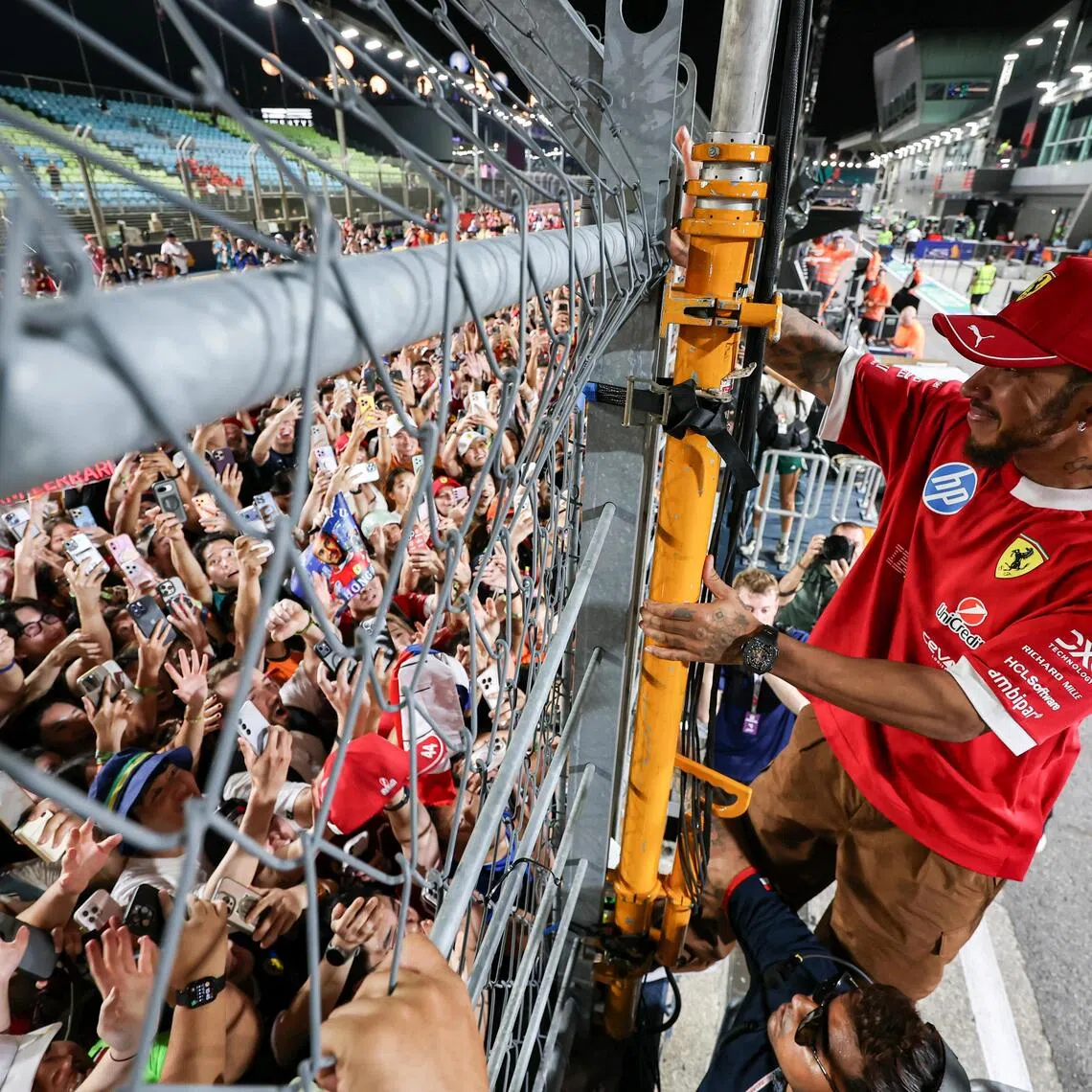 Ferrari driver Lewis Hamilton greeting fans after the race at the Marina Bay Street Circuit on Oct 5.