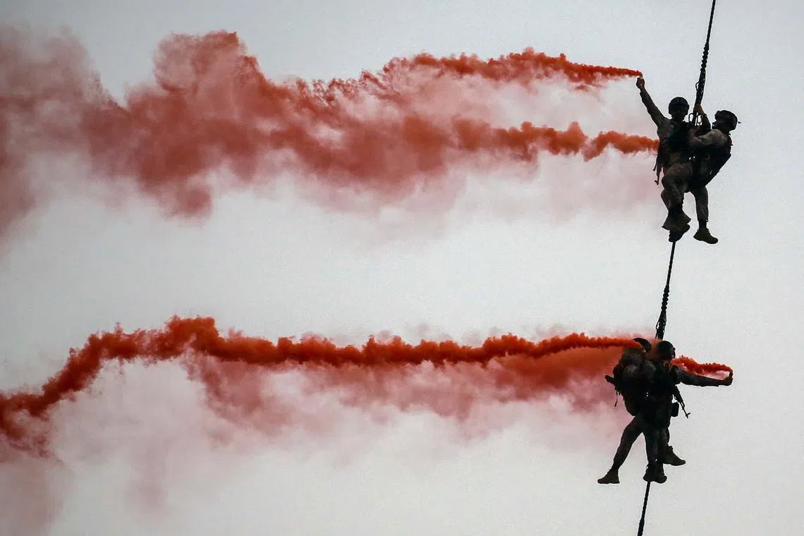 Indian Navy marine commandos demonstrating their rescue operation skills as part of Navy Day celebrations in Mumbai, India, Dec 14, 2023. 