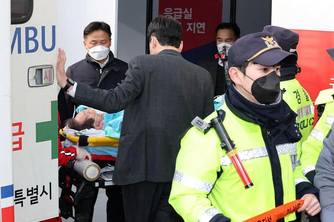 FILE PHOTO: South Korea's opposition Democratic Party leader Lee Jae-myung arrives on a stretcher at Seoul National University hospital after being stabbed in the neck by an unidentified man during his visit to Busan, in Seoul, South Korea, January 2, 2024.  Yonhap/via REUTERS/File Photo