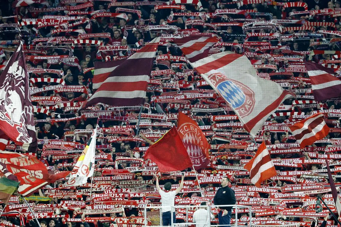 FILE PHOTO: Soccer Football - Champions League - Round of 16 - First Leg - Bayern Munich v Bayer Leverkusen - Allianz Arena, Munich, Germany - March 5, 2025  Bayern Munich fans with flags in the stands REUTERS/Heiko Becker/File Photo