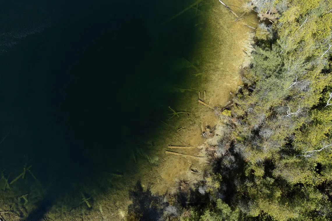An aerial view of Crawford Lake as a team consisting of scientists from Carleton University and Brock University gather sediment layer samples from the lake bottom at the Crawford Lake Conservation Area near Milton, Ontario, Canada on April 12. 