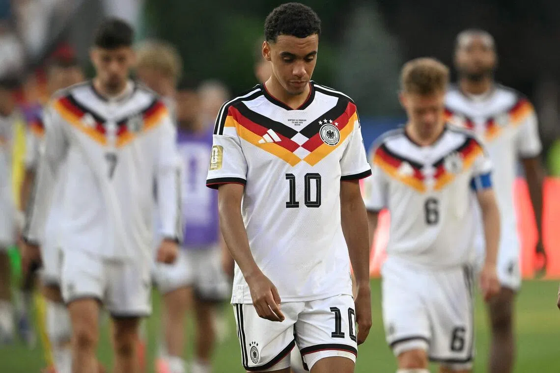 TOPSHOT - Germany's midfielder #10 Jamal Musiala reacts after losing the penalty shootout during the 2026 World Cup round of 32 football match between Germany and Paraguay at the Boston Stadium in Foxborough on June 29, 2026.  (Photo by MAURO PIMENTEL / AFP)
