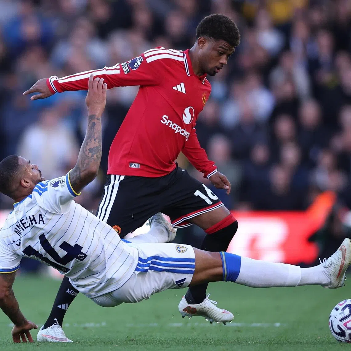 Lukas Nmecha of Leeds United trying to dispossess Amad Diallo of Manchester United in their English Premier League match on Oct 18 that ended 1-1.