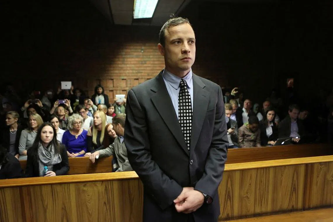 FILE PHOTO: Oscar Pistorius enters the dock before court proceedings at the Pretoria Magistrates court June 4, 2013. \"Blade Runner\" Pistorius arrived at court on Tuesday in his first formal appearance since his release on bail in February for the Valentine's Day killing of his girlfriend, 30-year-old model Reeva Steenkamp. REUTERS/Siphiwe Sibeko/File Photo