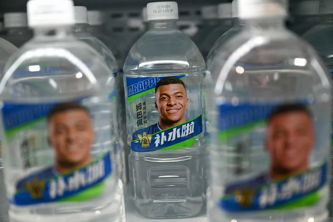 Bottles of Dongpeng Beverage Group’s Bushuila electrolyte drink featuring French football star Kylian Mbappe on the packaging.