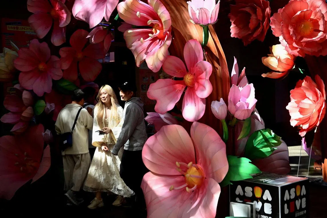 Visitors walking through an art installation in Chinatown in Sydney, Australia, on April 7, 2026. 
