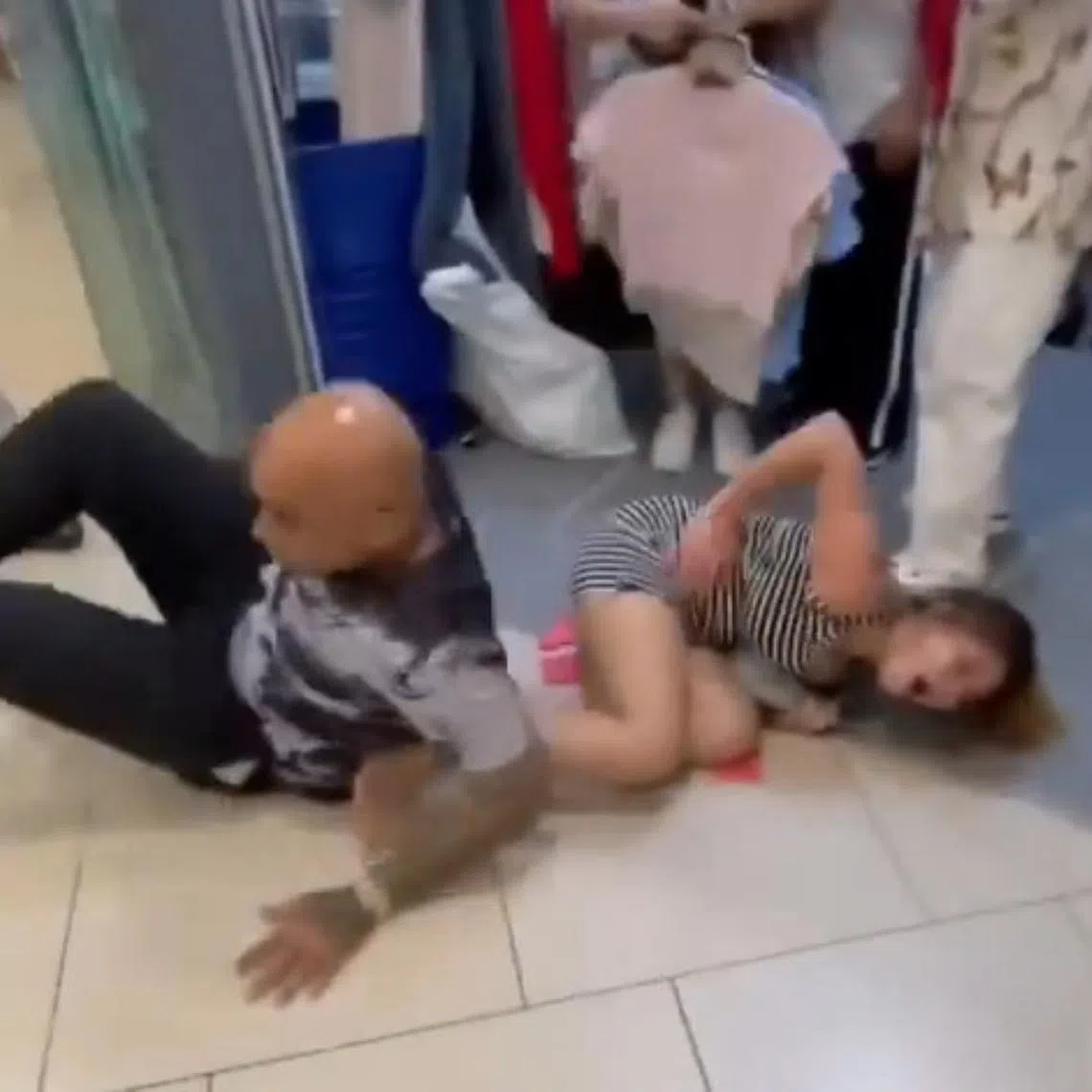 In videos circulating online, a man is seen kicking the woman, causing her to fall, before kicking again while she was still down.