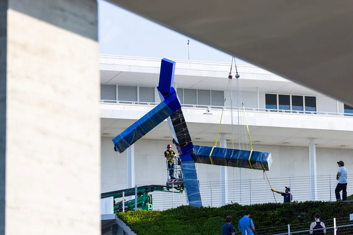 Workers remove a large sculpture called ‘Blue’ by artist Joel Shapiro from the grounds of the John F. Kennedy Center for the Performing Arts on Sept 2 in Washington DC, US.