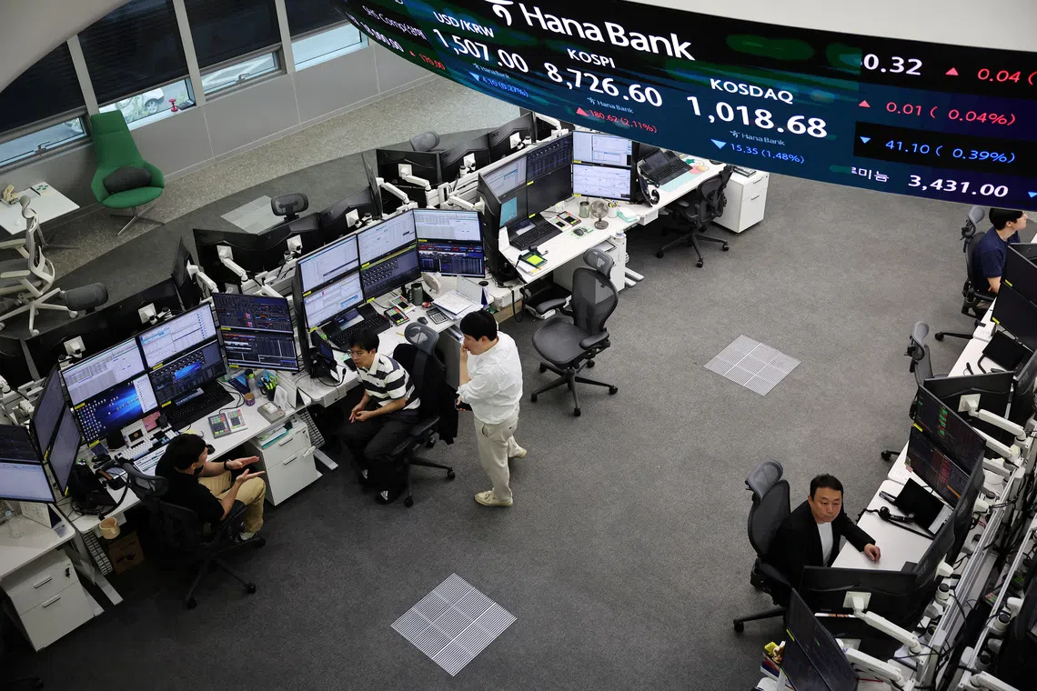 Currency dealers working a late-night shift in preparation for the launch of South Korea’s 24-hour won-dollar trading market at Hana Bank’s dealing room in Seoul, South Korea, on June 16.