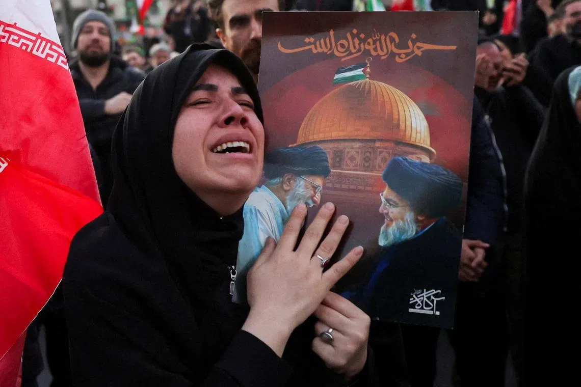 A woman reacting as people gather at the Enghelab Square, after Iran's Supreme Leader Ayatollah Ali Khamenei was killed in Israeli and US strikes on Saturday, in Tehran, Iran, on March 1, 2026. 
