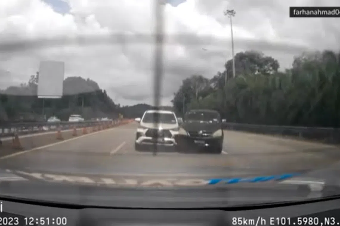 Two cars collided apparently due to confusing, overlapping yellow and white markings on the New Klang Valley Expressway in Malaysia. 