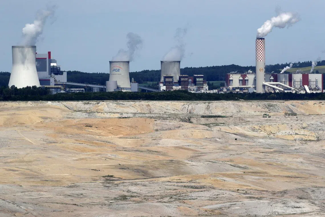 FILE PHOTO: The Turow coal-fired power plant is seen behind the Turow open-pit coal mine operated by the company PGE in Bogatynia, Poland, June 15, 2021. Picture taken June 15, 2021. REUTERS/David W Cerny/File Photo