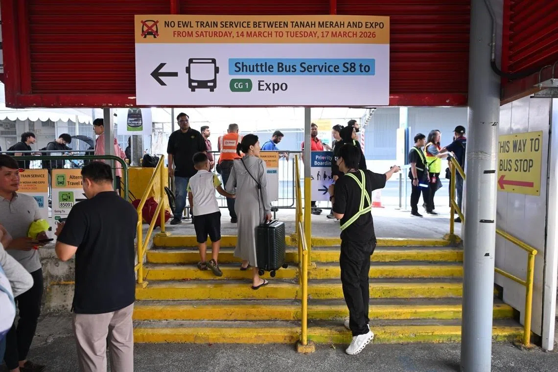 Staff directing passengers to shuttle service S8 at Tanah Merah MRT station on March 14.