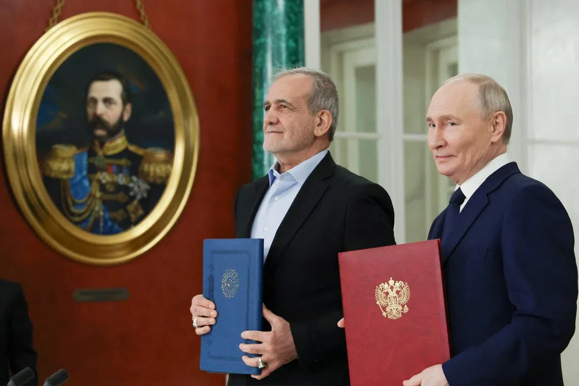 Russian President Vladimir Putin and Iranian President Masoud Pezeshkian attend a ceremony to sign an agreement of comprehensive strategic partnership between the two countries, at the Kremlin in Moscow, Russia January 17, 2025. Sputnik/Vyacheslav Prokofyev/Pool via REUTERS ATTENTION EDITORS - THIS IMAGE WAS PROVIDED BY A THIRD PARTY.
