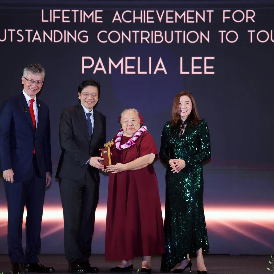 Tourism-sector pioneer Pamelia Lee (third from left) receiving an award award with (from left) STB chairman Olivier  Lim, PM Lawrence Wong and chief executive Melissa Ow.