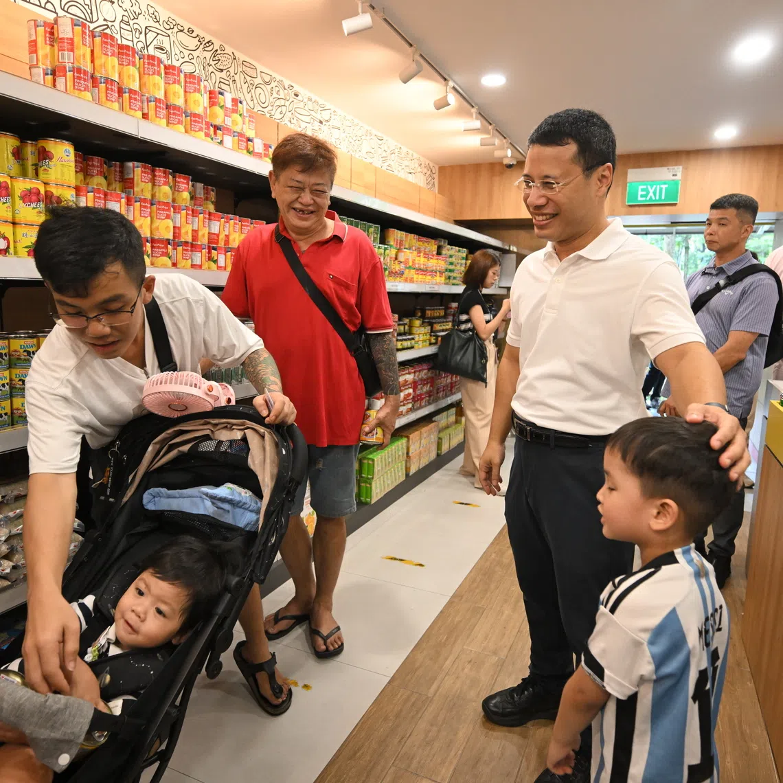 National Development Minister Desmond Lee with residents at the Food from the Heart Community Shop at Block 176 Boon Lay Drive on April 25.