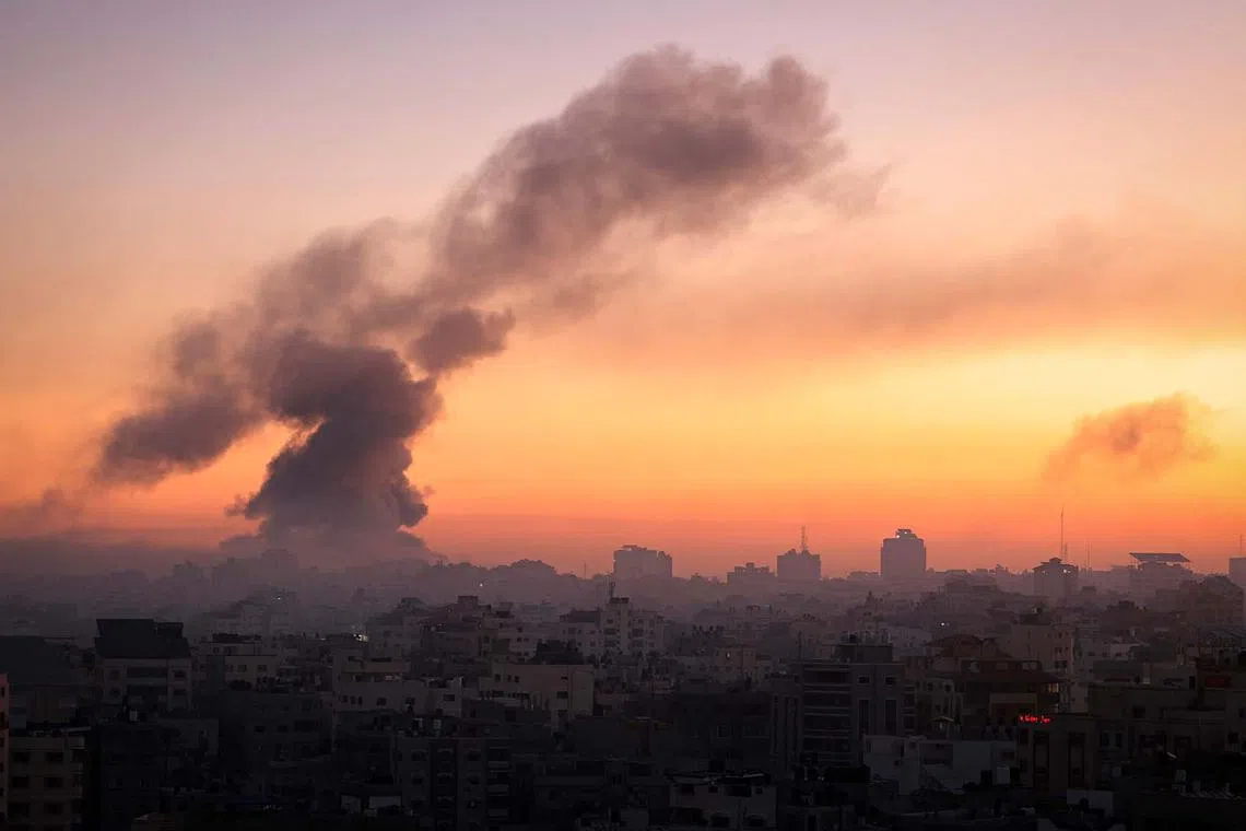 Fire and smoke rising above buildings in Gaza City during an Israeli air strike, on Oct 13, as raging battles between Israel and the Hamas movement continue for the sixth consecutive day. The United Nations was informed that Israel had ordered 1.1 million residents of northern Gaza to relocate to the south of the territory within 24 hours.
